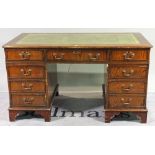 A 20th century hardwood pedestal desk with nine drawers about the knee,