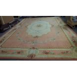 A Savonnerie carpet, French, the salmon pink field with a central ivory lozenge,