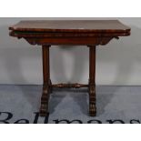A Regency mahogany card table, the fold over 'D' shaped top on a pair of trestle supports,