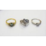 An 18ct gold ring, claw set with an oval cut aquamarine, between circular cut,