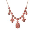 A gold and garnet necklace, the front with a foliate capped flowerhead shaped drop,