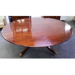 Williams Tillman; a George III style circular mahogany dining table on four downswept supports,