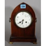 An early 20th century mahogany cased clock of lancet form on brass bracket feet,