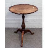A 19th century occasional table, the shaped circular top on baluster column and tripod base,