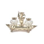 A Victorian silver twin bottle inkstand, of shaped oval form, decorated with scrolling border,