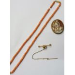 A single row necklace of coral beads, on a cylindrical clasp,