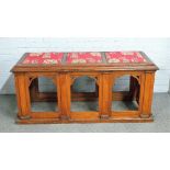 A 19th century Gothic Revival oak bench, with padded seat, over pierced arch base,