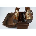 A late Victorian silver mounted leather cased part dressing set,