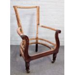A Regency mahogany chair frame, with outswept acanthus scroll arms on tapering reeded supports,