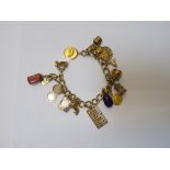 A gold decorated curb link charm bracelet, on a snap clasp, detailed 14 K,