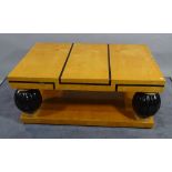 A 20th century satin birch and ebony inlaid rectangular coffee table on ebonised reeded bulbous