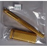 A Cartier gold plated lighter and a matching Cartier ball point pen, (2).