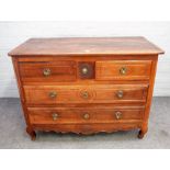 A late 18th century French walnut commode with a pair of short drawers over two long graduated