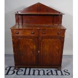 A late Victorian mahogany chiffonier with two drawers over walnut panelled doors on bun feet,
