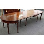 A 19th century 'D' end extending dining table with central drop flap section and two extra leaves