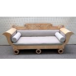 A Biedermeier birch sofa with urn and scroll crest and cornucopia arms on a trio of turned supports,