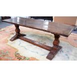 A 17th century style oak refectory tale, the cleated plank top on square baluster supports,