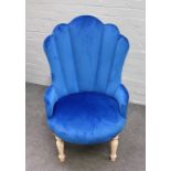 A Victorian style button back armchair, with studded blue upholstery, on turned supports,