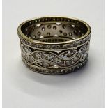 A diamond set wide band full eternity ring, in a pierced openwork design,