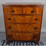 A Victorian mahogany bowfront chest of two short and three long drawers on turned supports,