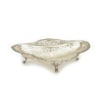 A silver dish, of trefoil shaped form, having scroll pierced decoration within a gadrooned rim,