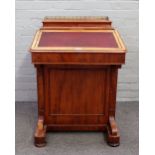 A Victorian mahogany Davenport with fitted galleried super structure over sloped front and four