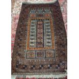 An Afghan Beluche prayer rug, the mehrab with three columns, rising to three arches,