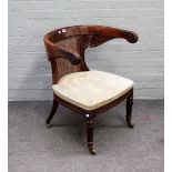 A William IV mahogany tub back desk chair, with scroll arm finials, on reeded supports,