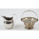 A George III silver helmet shaped cream jug, London 1803 and a Victorian silver basket,