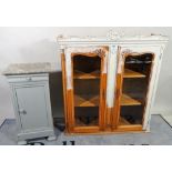 A 20th century French display cabinet with arched panelled glazed doors,