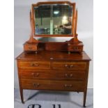 An Edwardian inlaid mahogany dressing chest with rectangular mirror and two short and two long