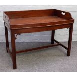 A 19th century mahogany bowfront butlers tray with loop handles, on later stand,