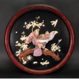 A Japanese ivory, wood and mother of pearl inlaid circular lacquer panel, Meiji period,