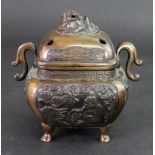 A Chinese or Japanese bronze two-handled censer and cover, circa 1900, of rounded square form,