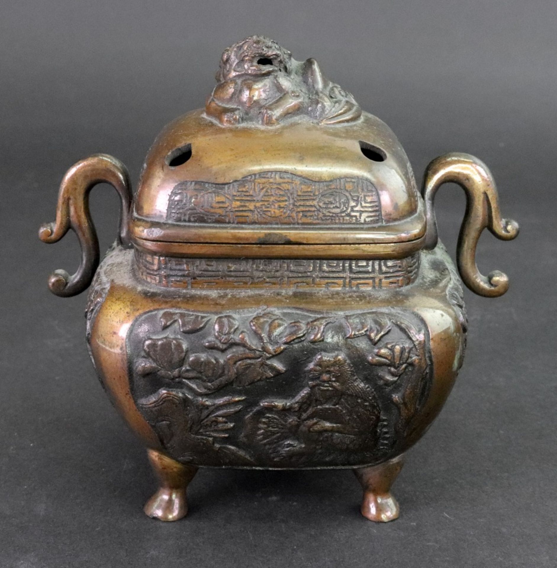 A Chinese or Japanese bronze two-handled censer and cover, circa 1900, of rounded square form,