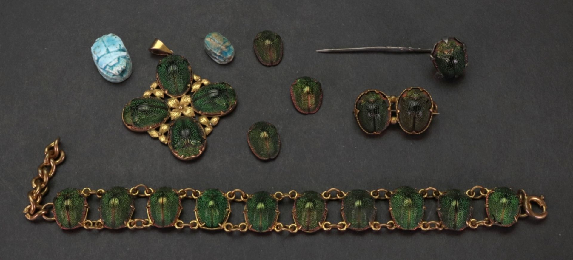 A collection of gilt metal mounted scarab beetle jewellery,