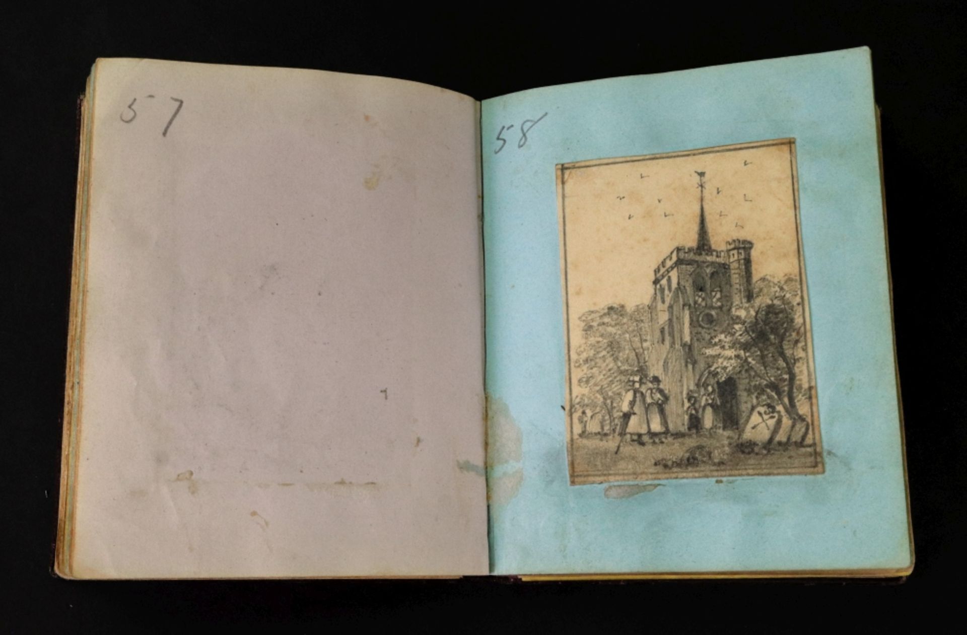 A small Victorian gilt tooled crushed morocco album, containing a collection of watercolours,