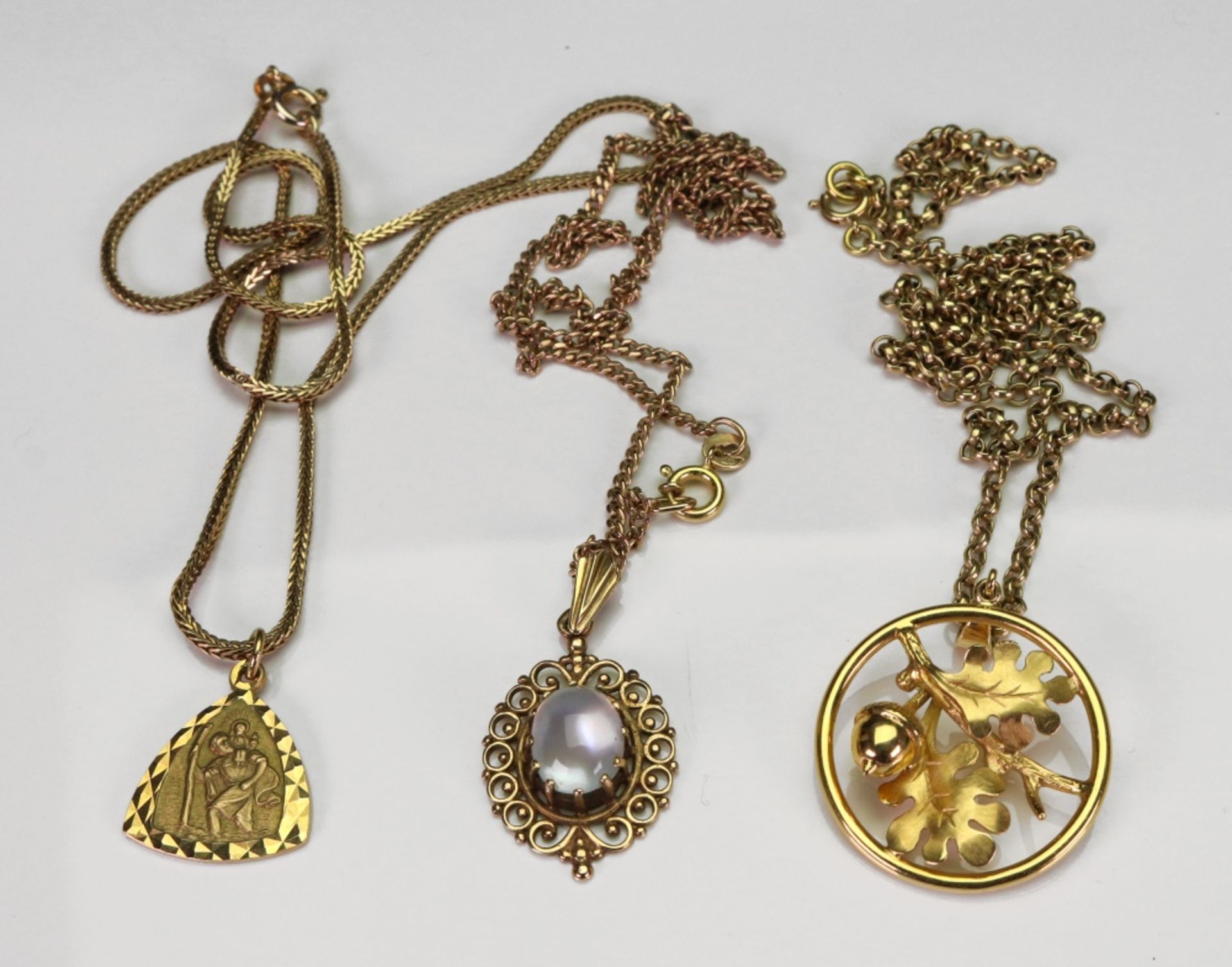 A collection of three 9ct gold pendant necklaces,