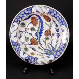 An Iznik pottery dish, 17th century or possibly later, painted in blue, green,