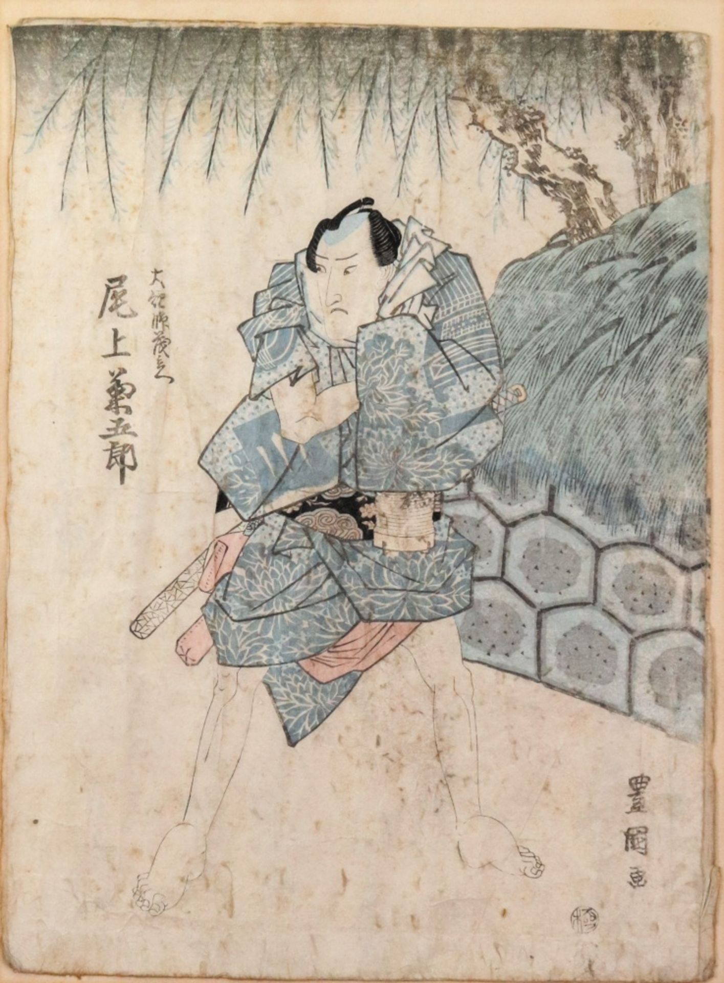 A Japanese picture of a samurai, Meiji period, standing beneath a tree, signed and titled,