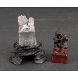 A small Chinese rock crystal carving of a Buddhist lion, standing on a rectangular plinth, 4.