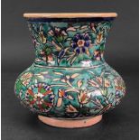 An Iznik pottery baluster vase, painted with flowering branches against a turquoise ground,