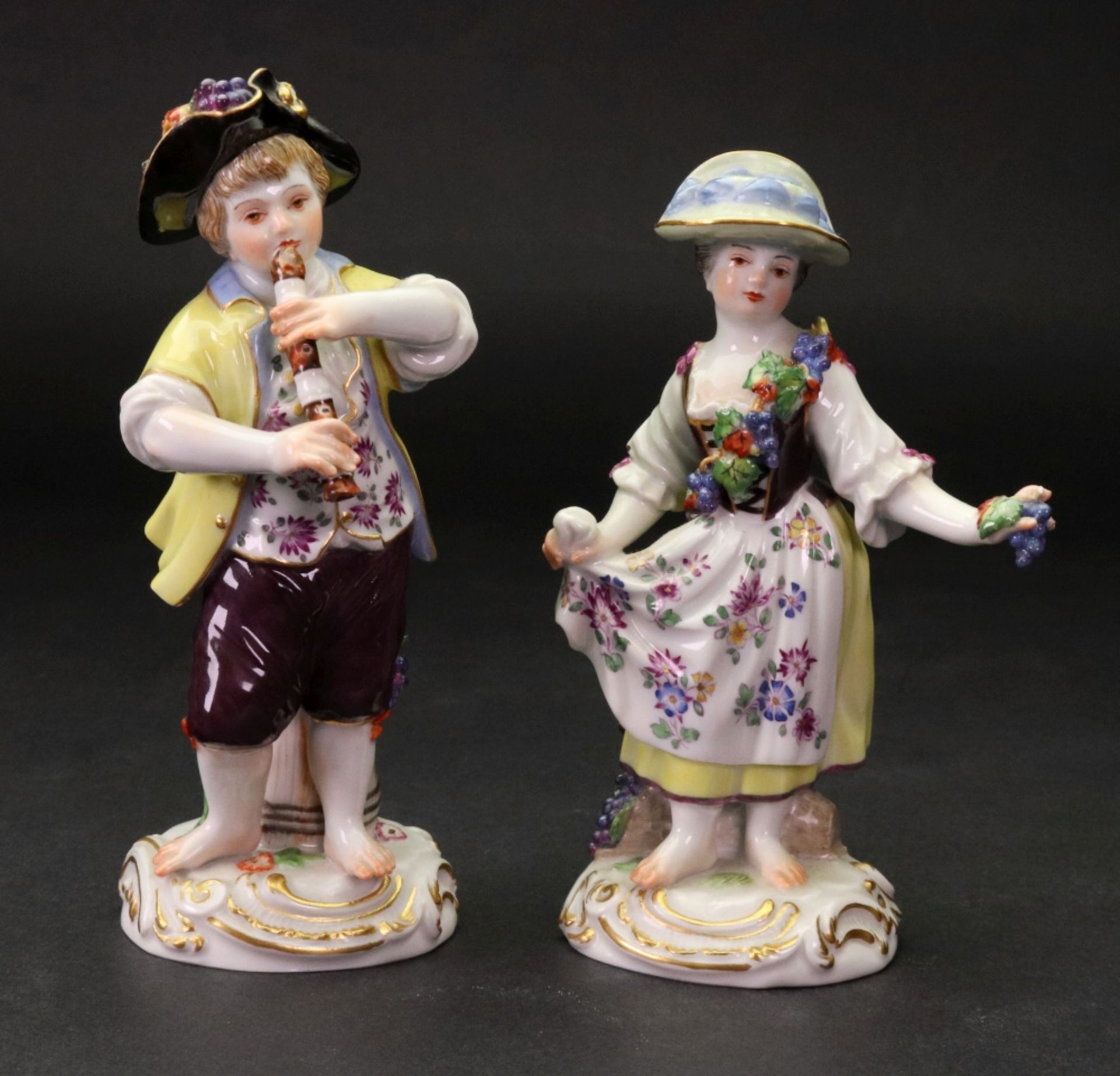 A pair of Meissen figures of vintners, 20th century, a boy playing a recorder,