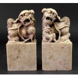 A pair of Chinese soapstone groups of Buddhist lions, the male with a brocade ball,