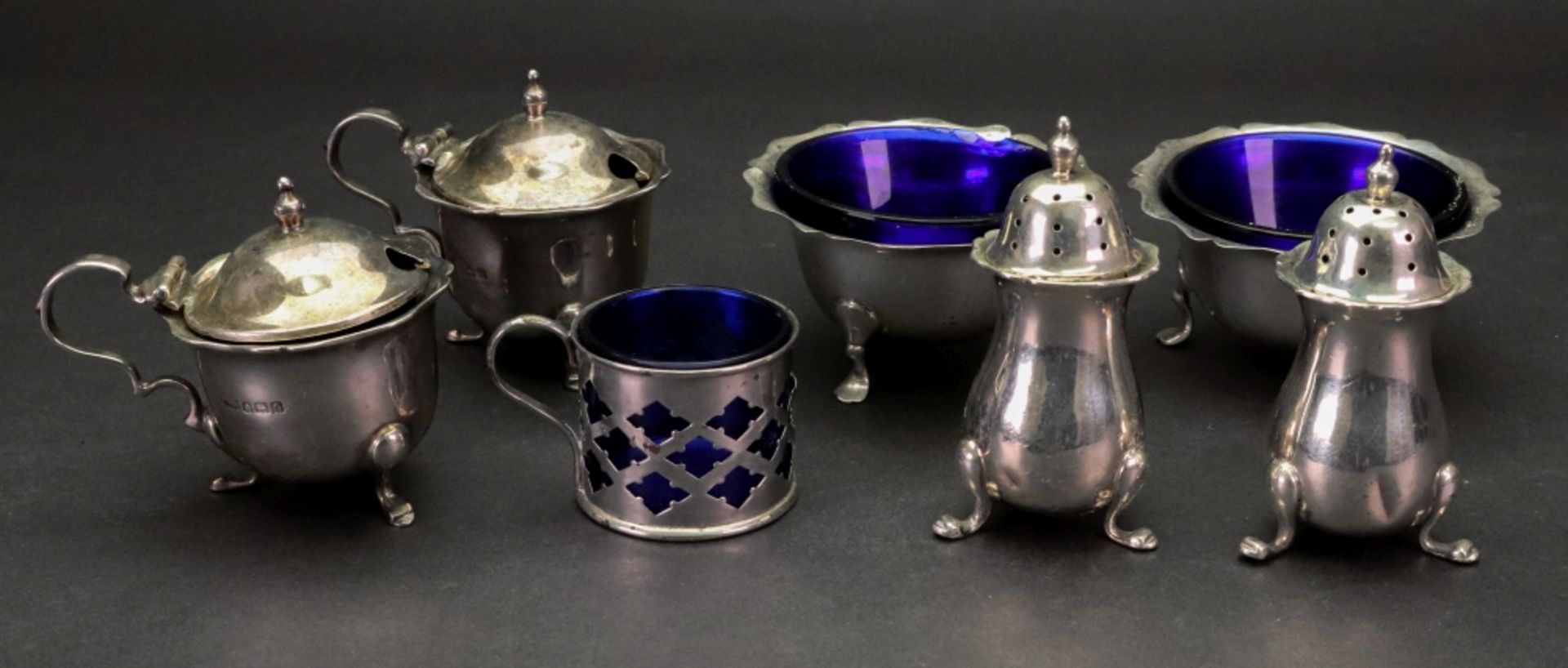 A George II style silver four piece cruet set, Birmingham 1913, with shaped rims,