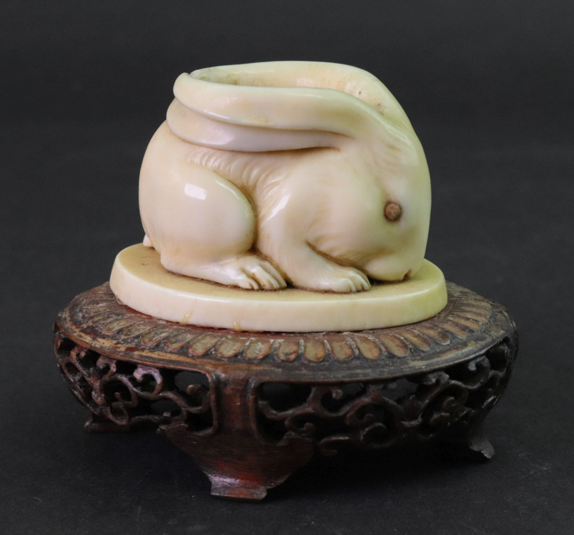 A Japanese marine ivory figure of a hare, Meiji period, modelled crouching with ears pinned back,