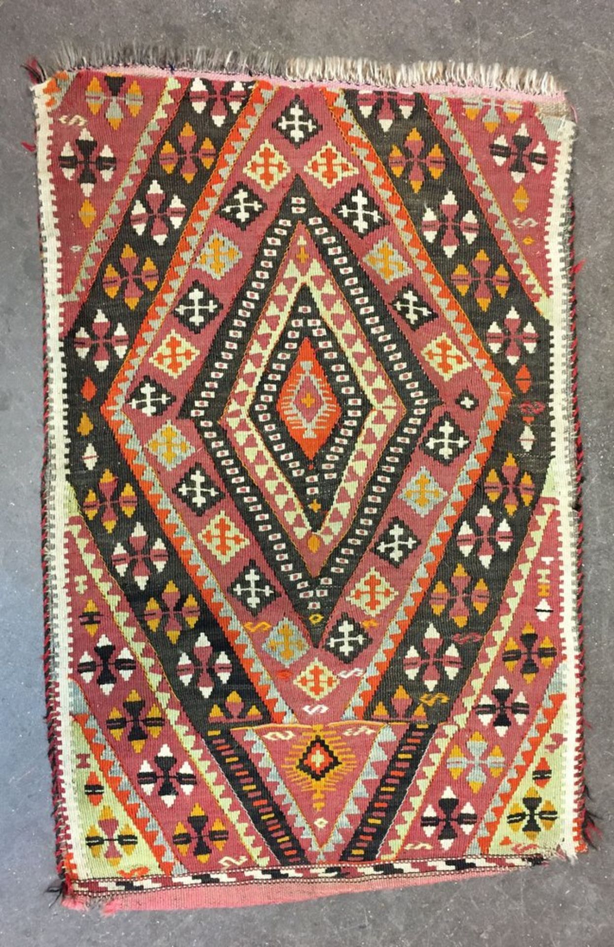 An Afgan Bokhara rug, with two rows of quartered guls on a rust ground, 176 x 125cm, - Image 2 of 3