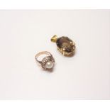 A gold ring, mounted with a cultured pearl within a pierced surround,