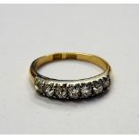 A gold and diamond set seven stone half hoop ring, mounted with a row of cushion shaped diamonds,