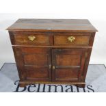 A 19th century and later oak dresser base with two drawers over cupboard base,